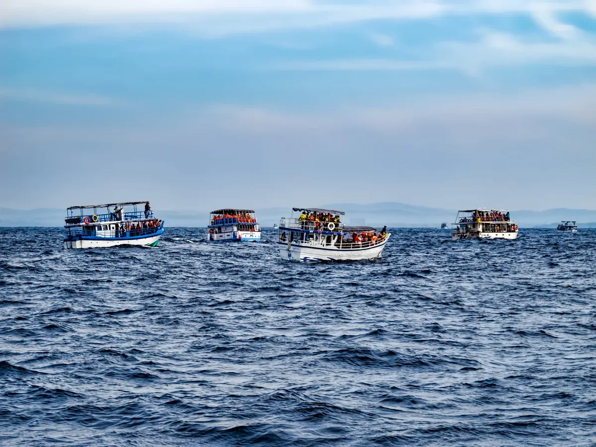 Shared whale watching boats heading offshore from Mirissa on Mirissa whale watching tours, Sri Lanka
